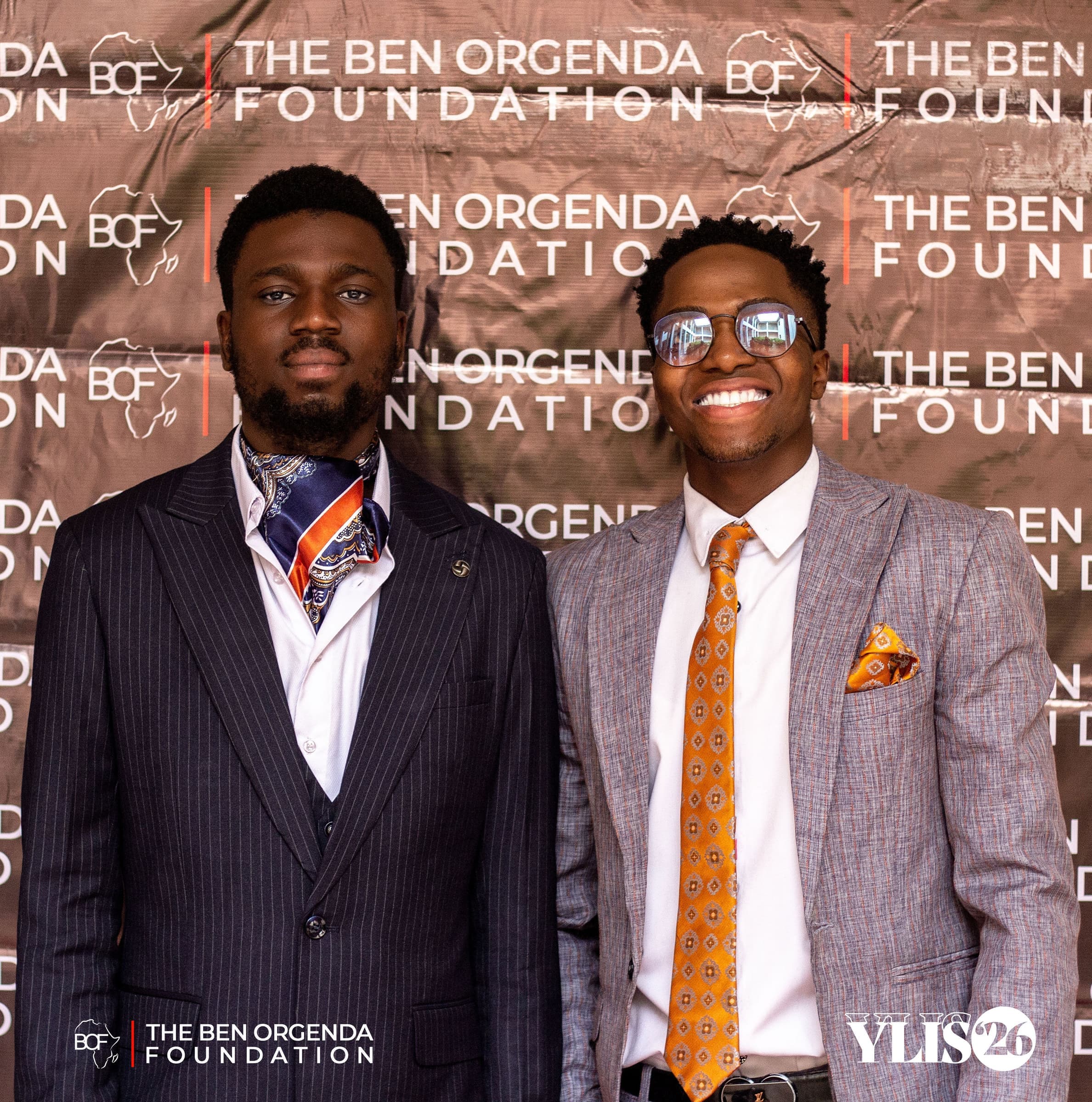 Two guests in suits at the foundation's photo wall