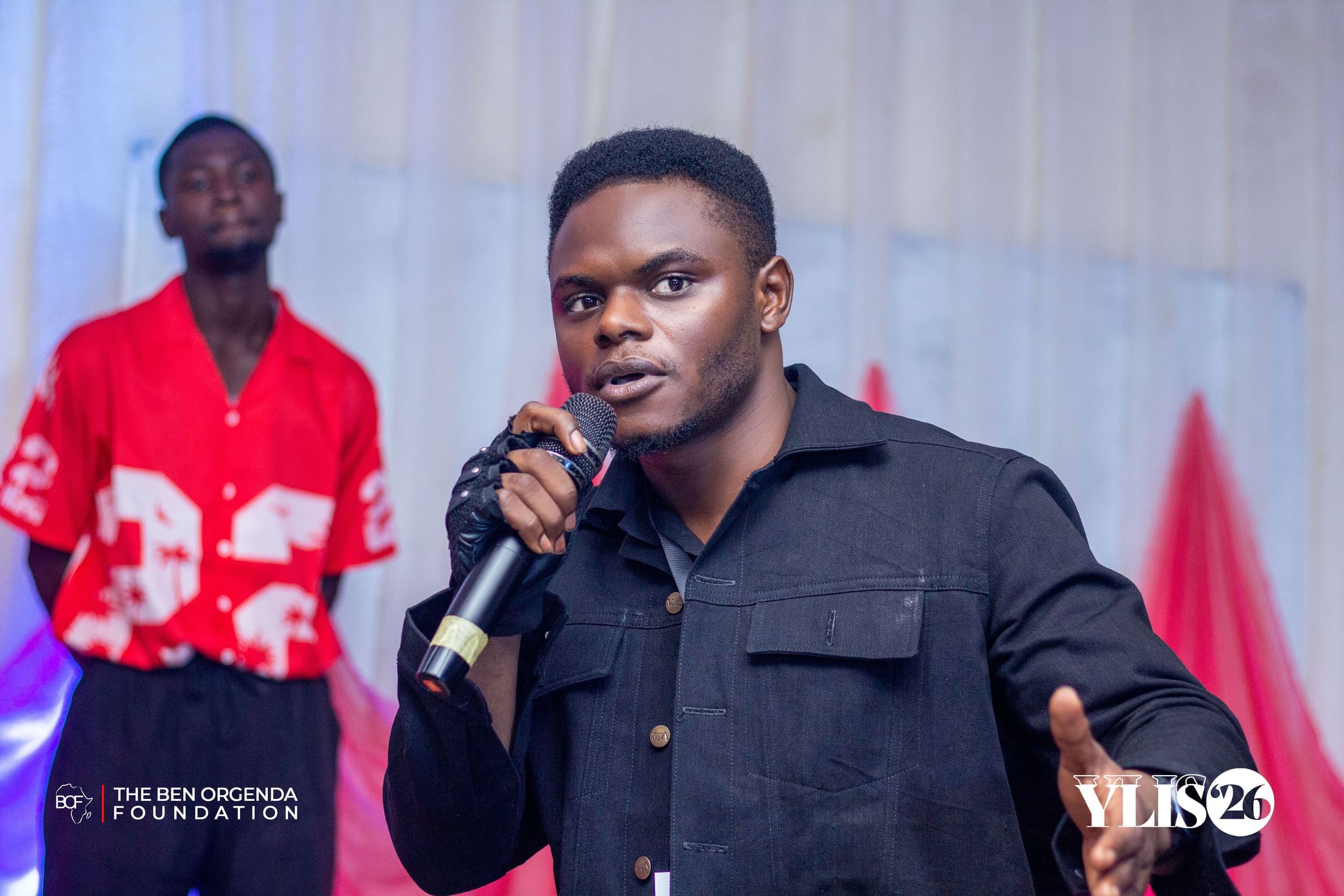 A young man speaking into a microphone
