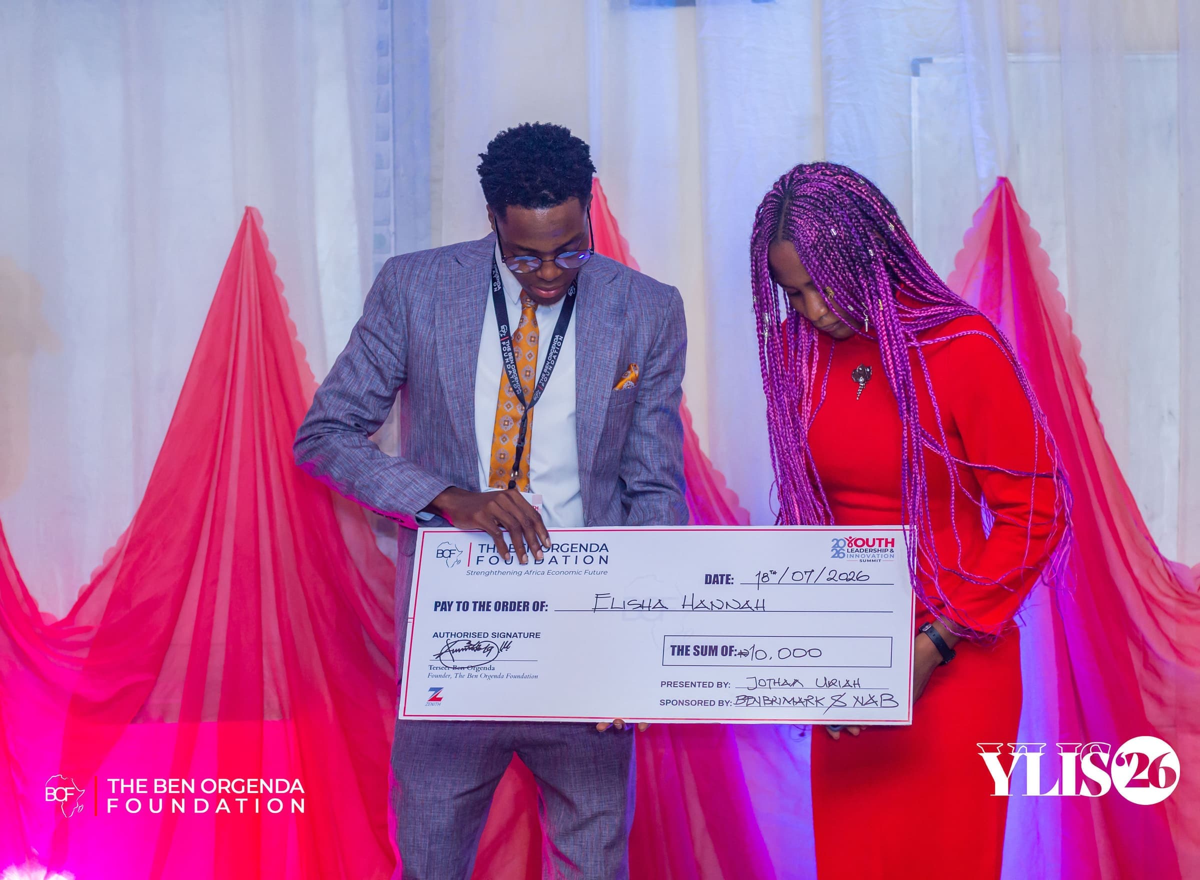A prize cheque being presented on stage