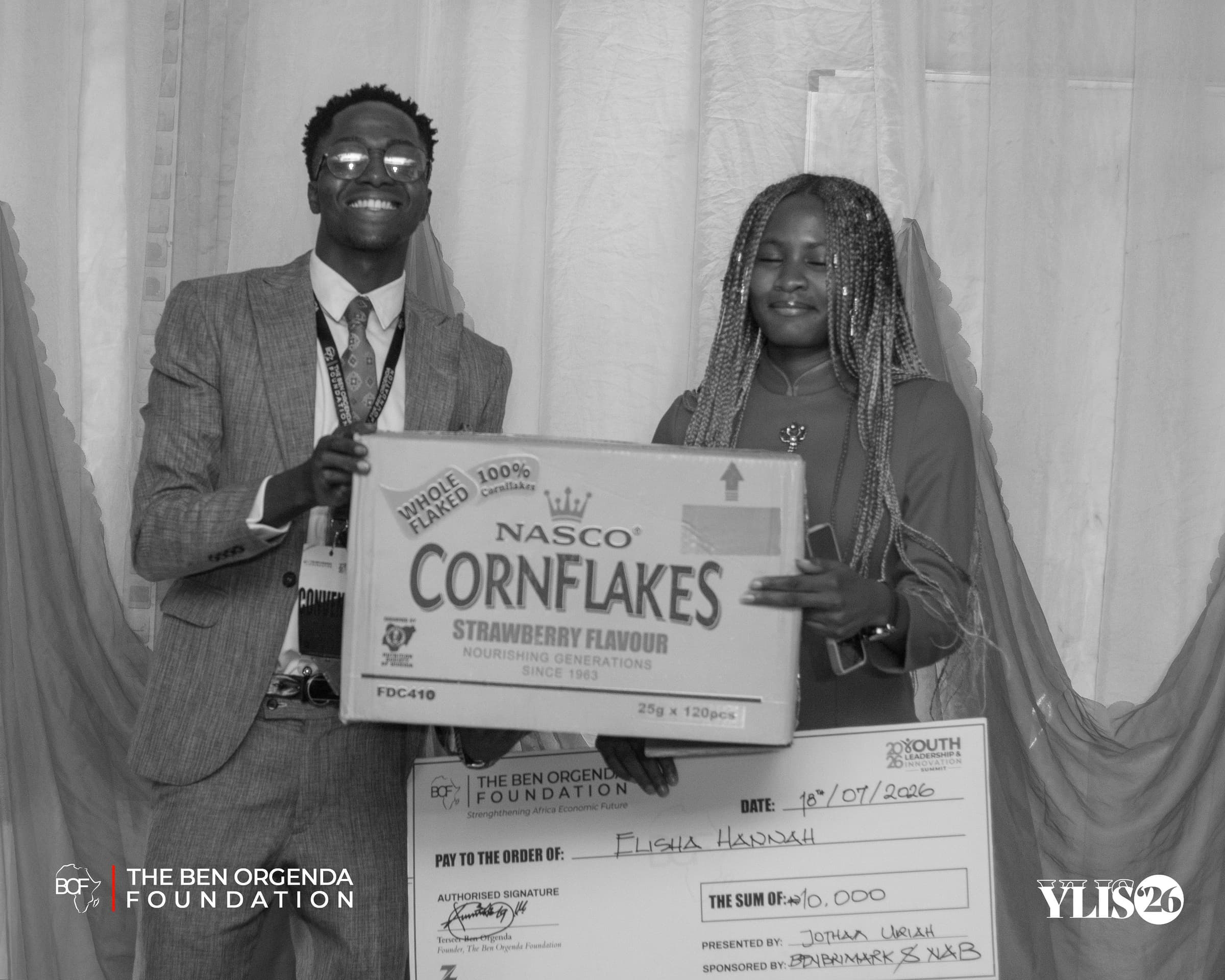 Black and white photo of a prize presentation on stage
