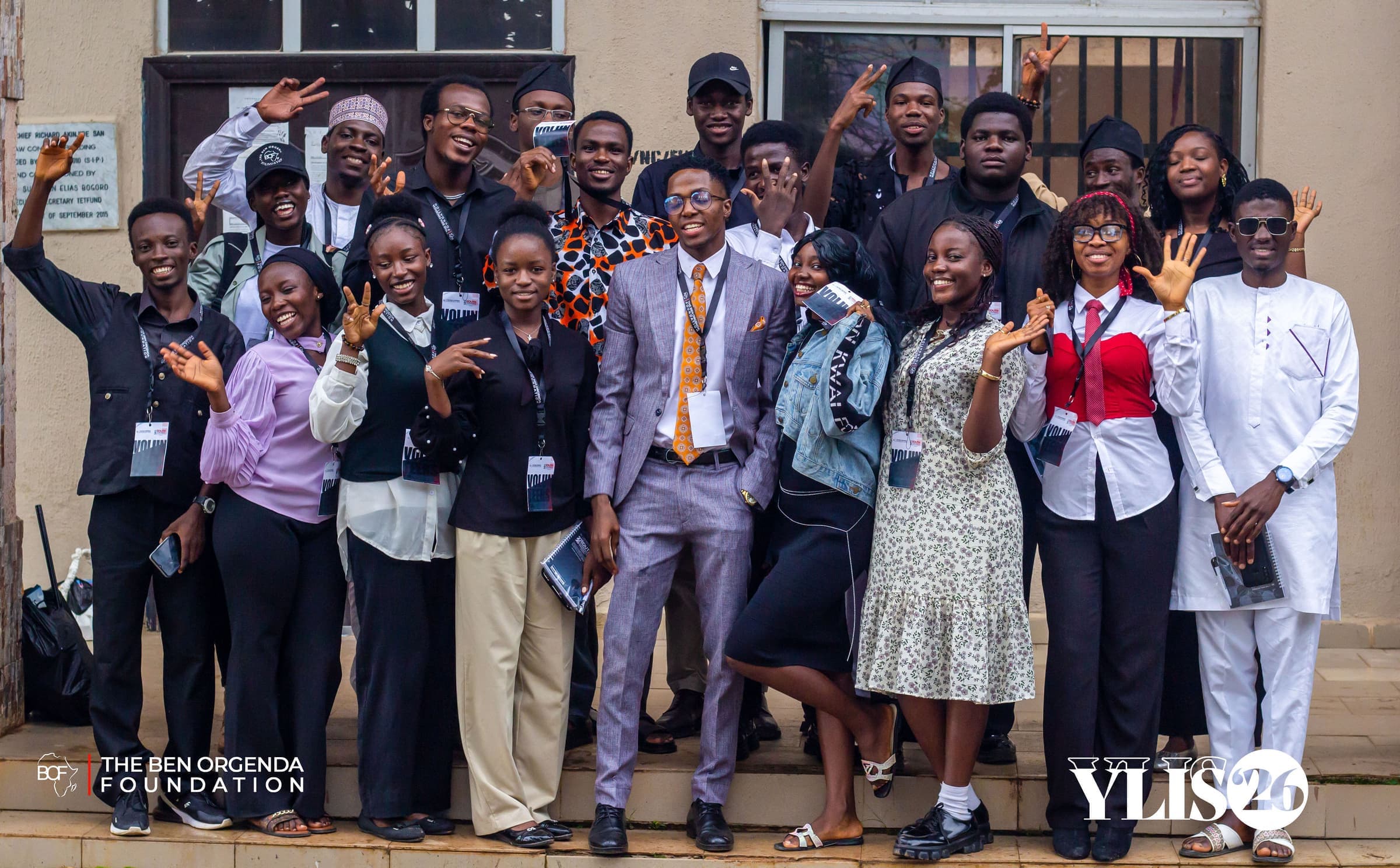 YLIS 2026 participants cheering in a group photo outside